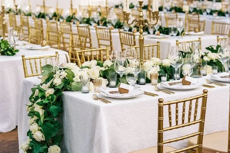 gold candelabra and cheesecloth table runners creating elegant wedding backdrop layers in Kelowna BC