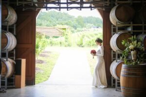 wine barrel rental Okanagan set up as ceremony altar with floral arrangements at vineyard wedding