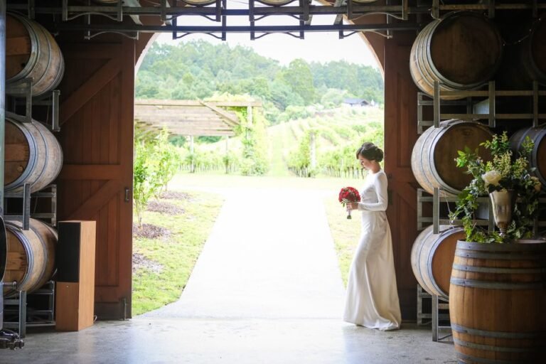 wine barrel rental Okanagan set up as ceremony altar with floral arrangements at vineyard wedding