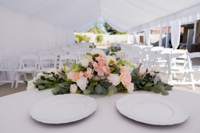 white marquee tent set up for summer tent wedding in BC with sidewalls open for airflow